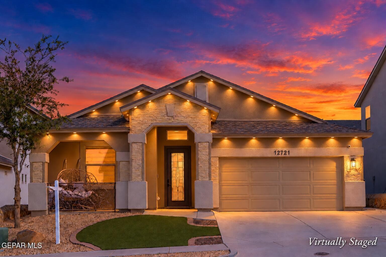 Stucco exterior with stone accents, Govee soffit lighting, a two-car garage, and a covered entry