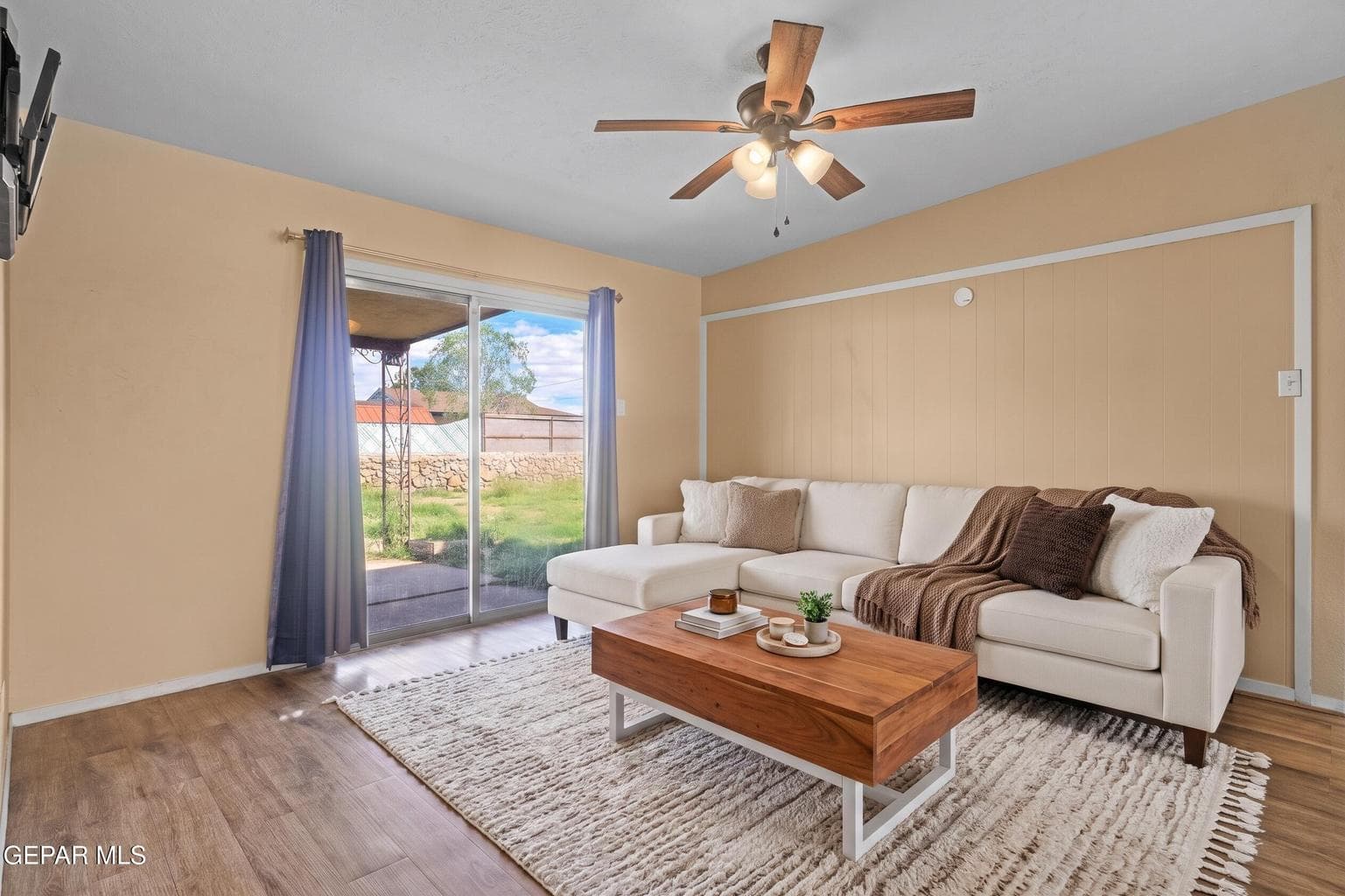 Enjoy a spacious layout, ceiling fan, and backyard access. This photo was AI generated to highlight the homes features and potential.