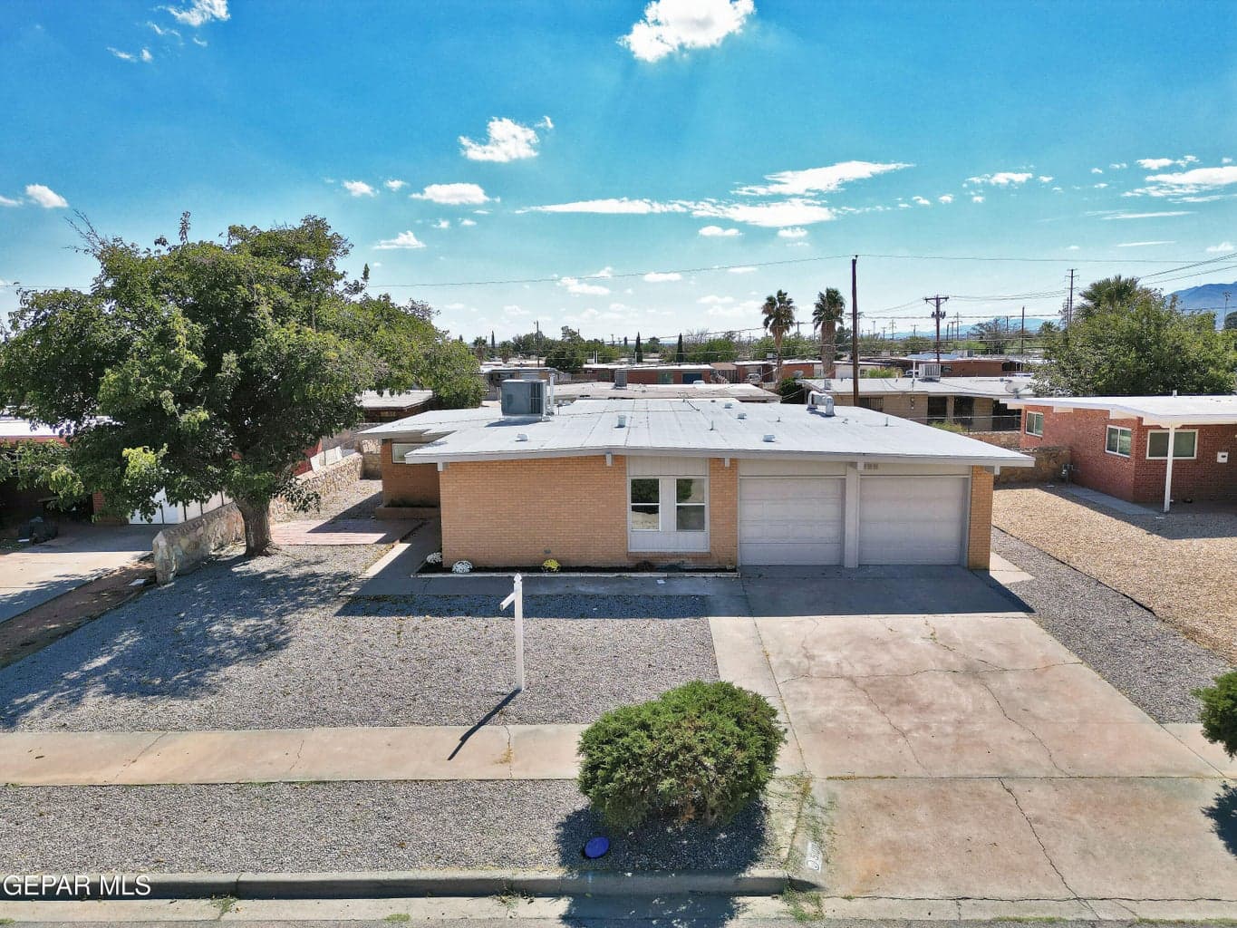 Elevated front view in Milagro Hills with driveway and gravel landscaping