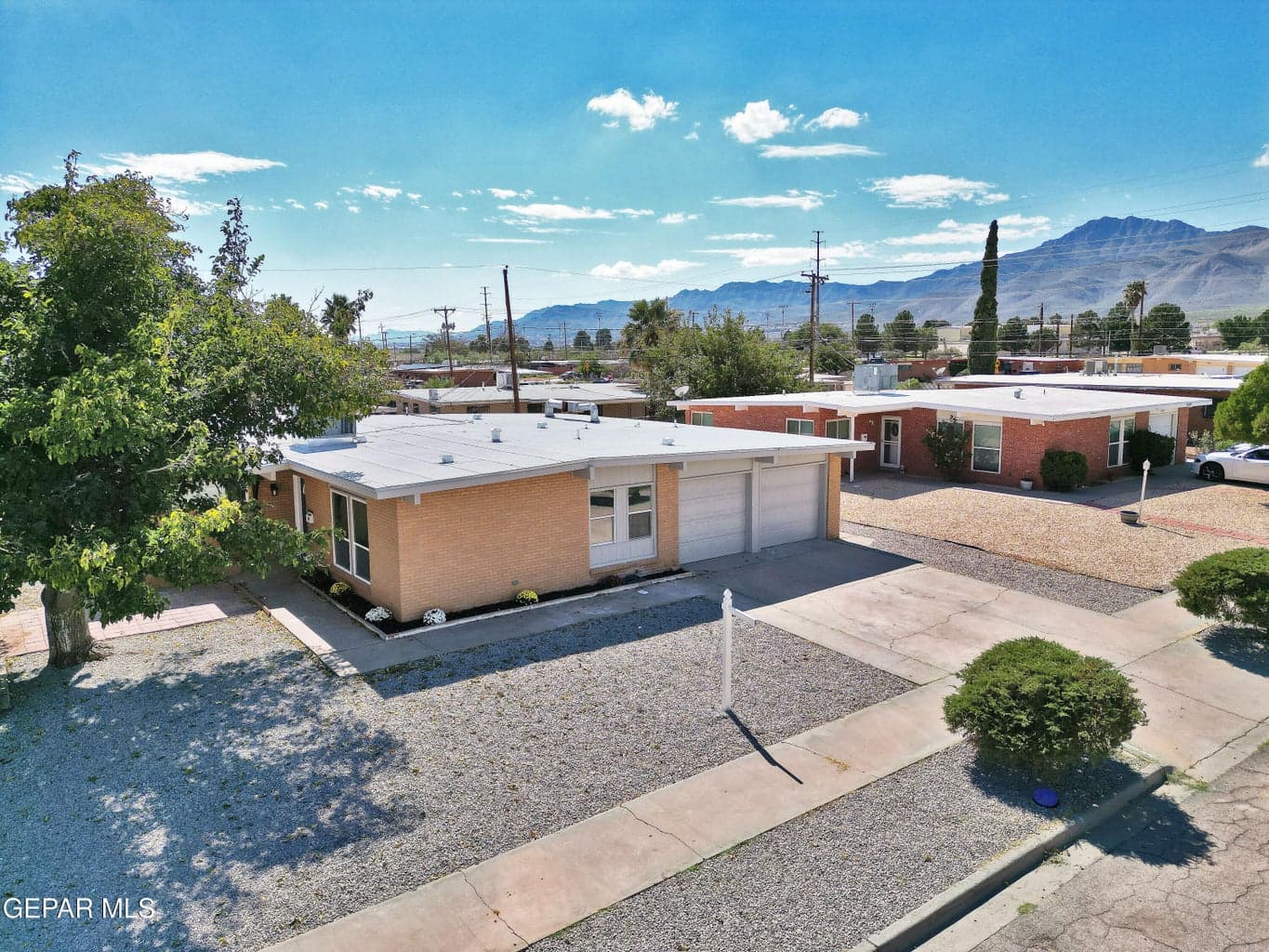 Angled aerial view of the home and front yard