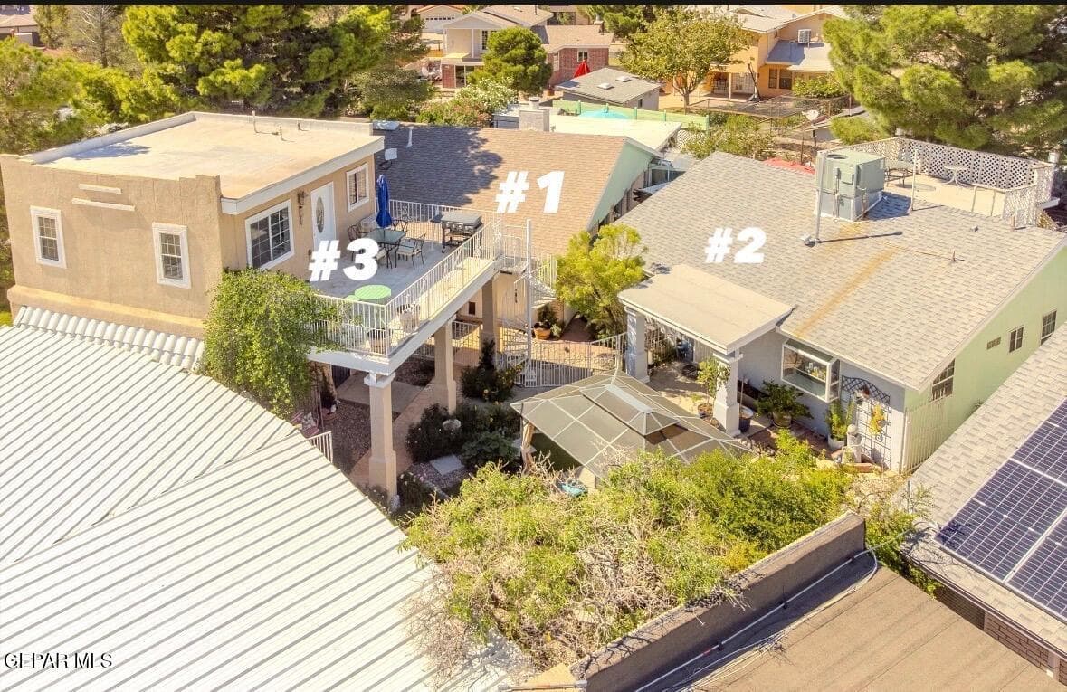 Aerial view of the three homes, showcasing the shared courtyard, outdoor entertaining area, and individual rooftop layouts