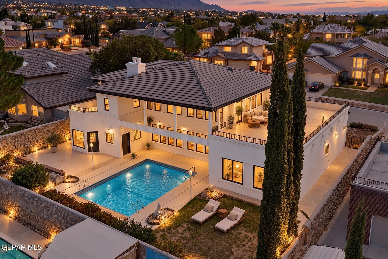 Blue-hour aerial pool retreat