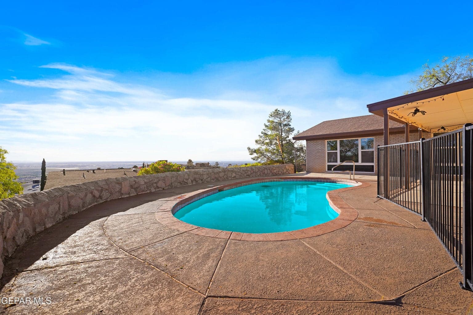 The in-ground pool serves as a standout outdoor feature, offering a refreshing place to unwind