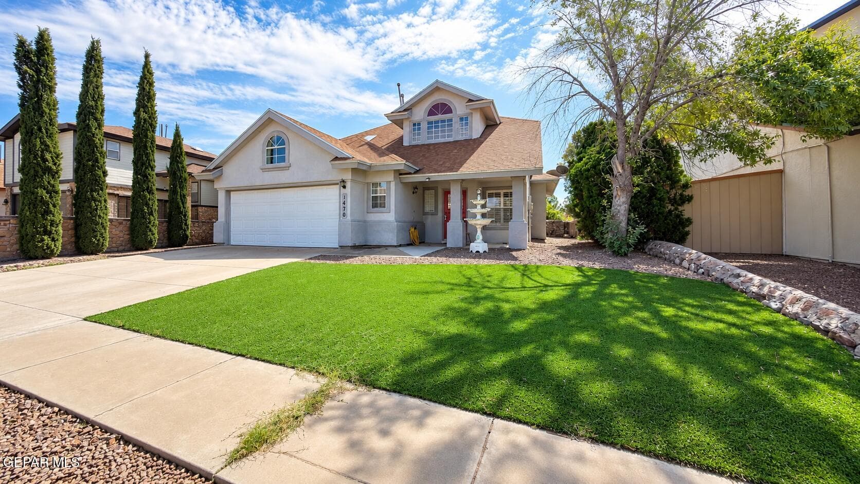 Additional view of the home's exterior and front lawn. Digitally enhanced
