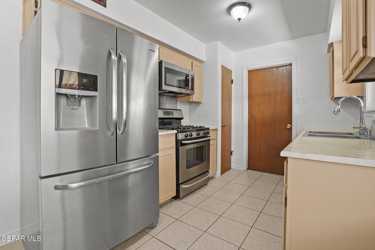 Features tile flooring, ample cabinetry, and a functional layout.