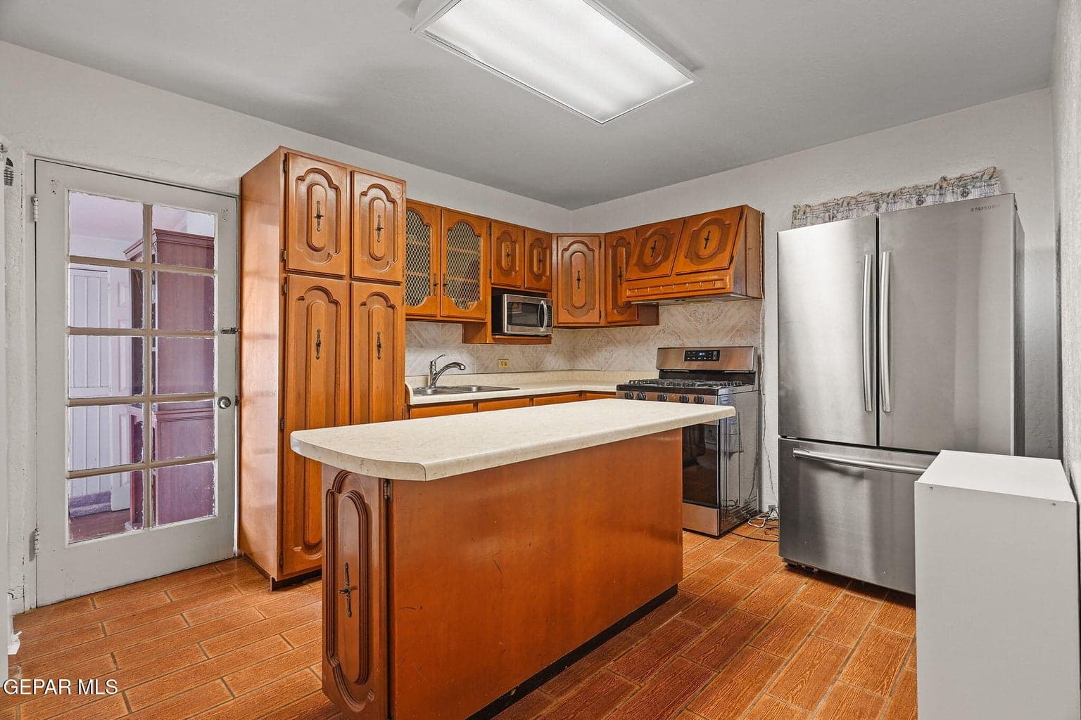 The kitchen features ample cabinetry and a practical layout for meal preparation.