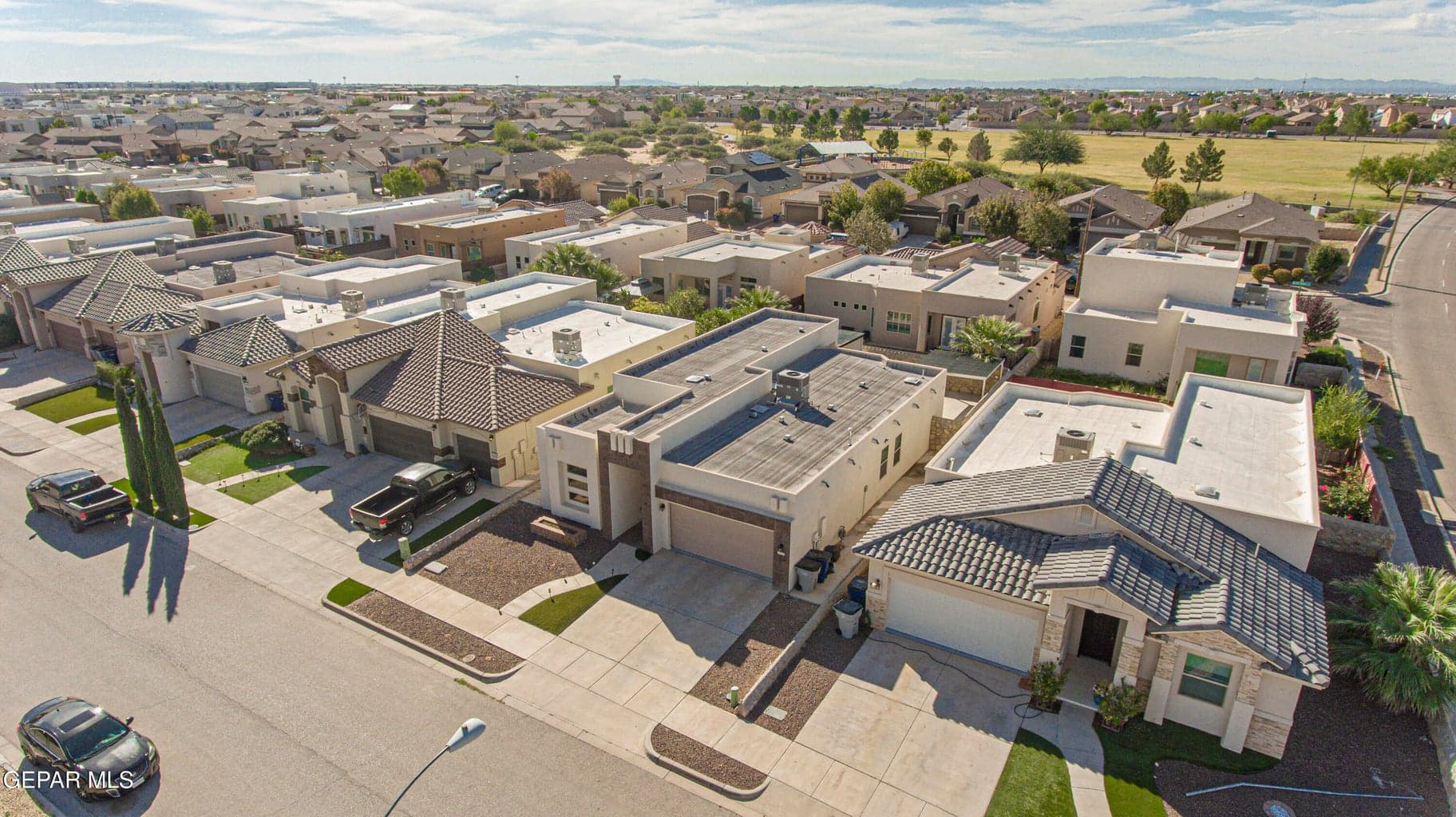 Aerial perspective showcasing a residential lot with a double car garage, and desert-inspired xeriscaping