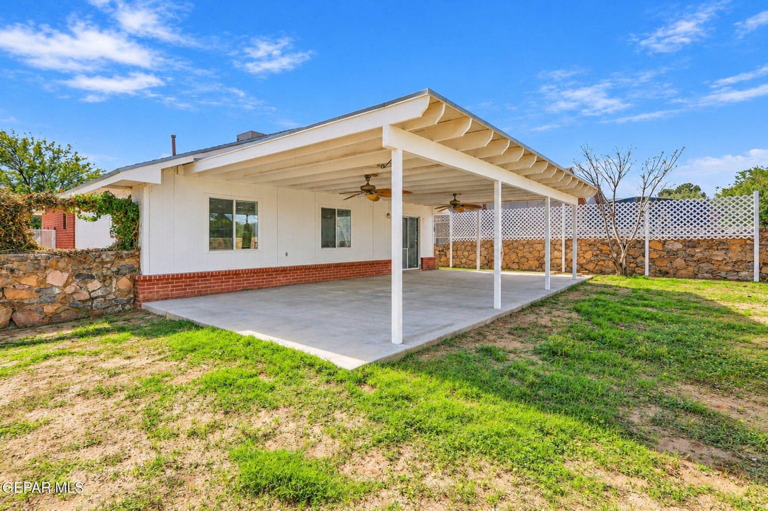 Spacious 416 sq. ft. covered patio overlooking a private backyard, perfect for outdoor entertaining, dining, and relaxing in the shade