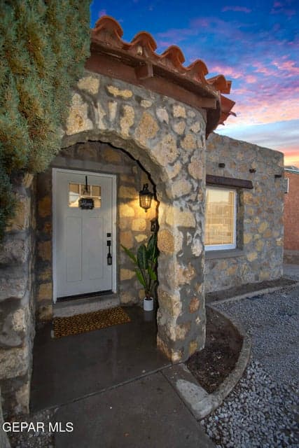 Darling rock home w/ a charming entrance.