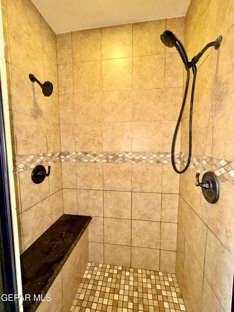 Has dual shower heads and a sit down bench